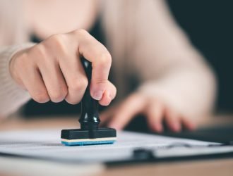 business woman validates and manages business documents and agreements,legal contract,signing business contract approval ,joint venture agreement,contract documents confirmation ,approval stamp